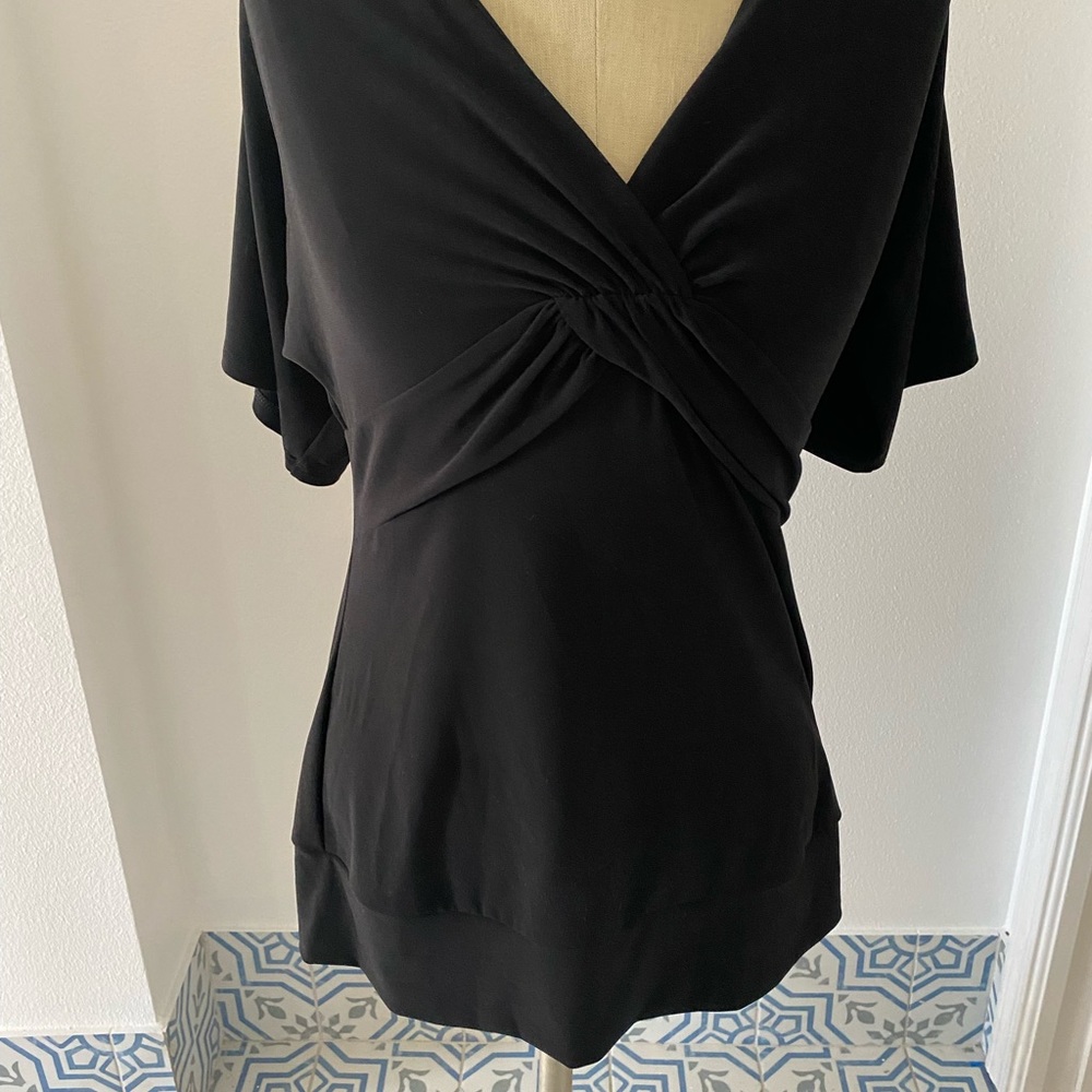 Like new WHBM black Top with sexy back. Size medium